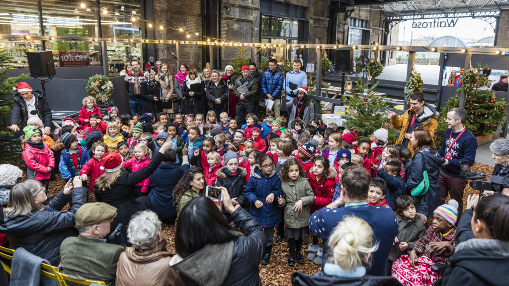 The children of King's Cross Academy singing carols in the West Handyside Canopy